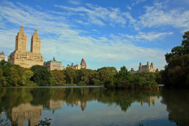 a body of water in front of some buildings and trees