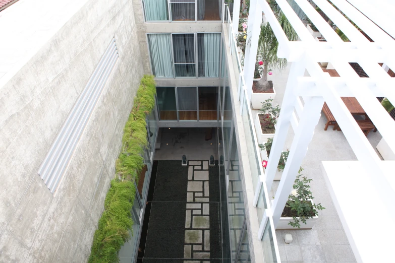 a view from above of two buildings and the grass in the ground