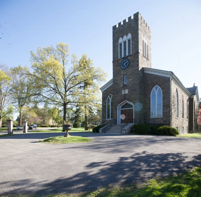 a small church building with three clocks