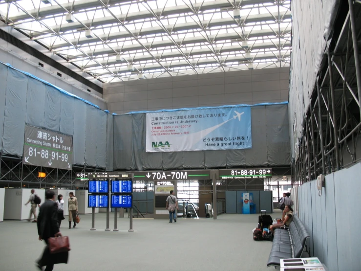 an asian airport with lots of people walking