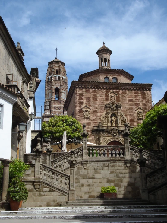 an old building with a tower near a bunch of houses