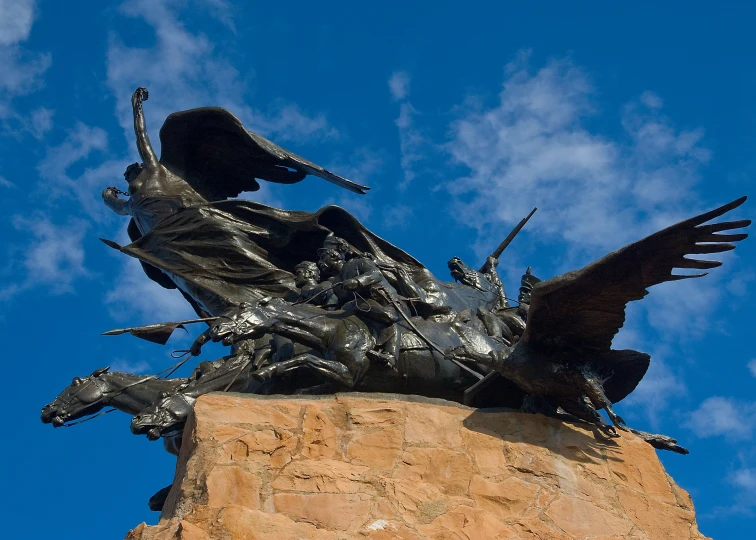 a close up of a statue with birds flying above