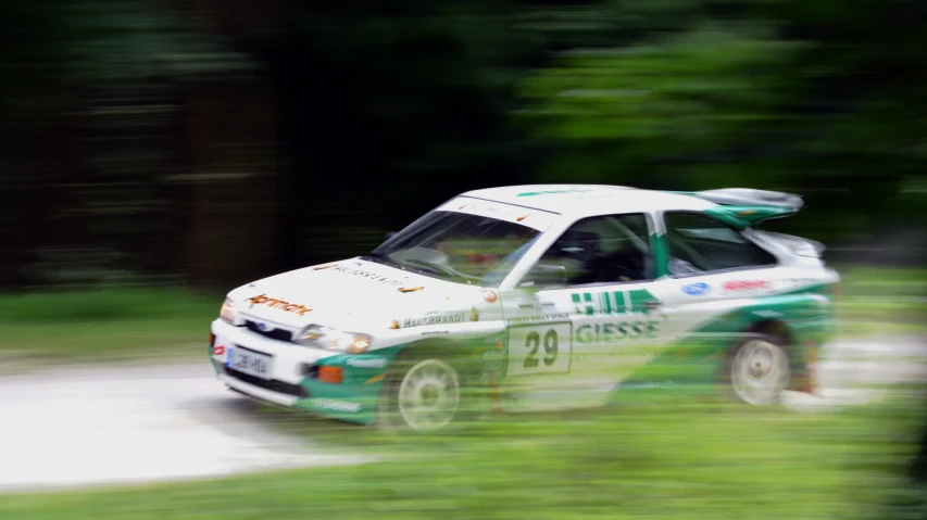 an image of car racing on a dirt road