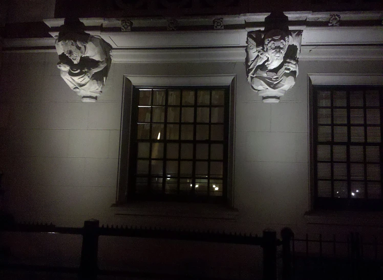 two decorative gargons on the side of a building