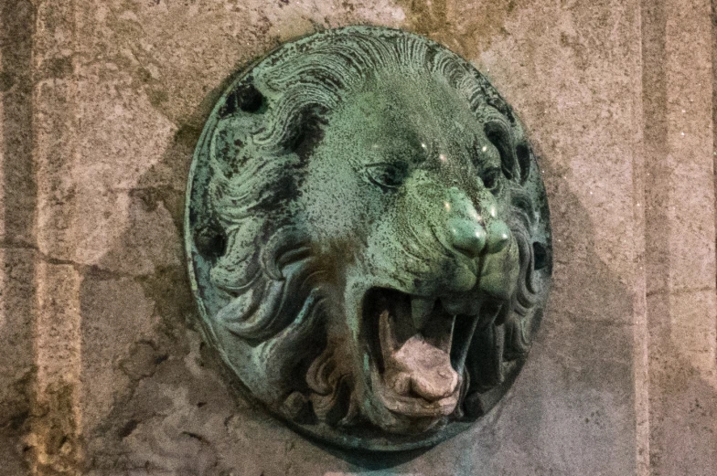 a clock that has a lion head on it