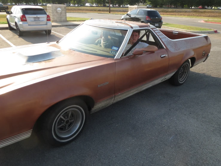 a man in a sports car with a hat on