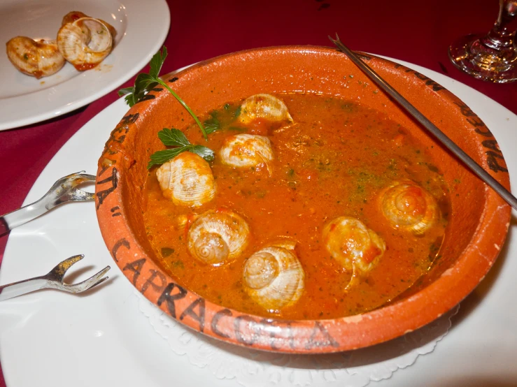 some food in a bowl is sitting on a plate