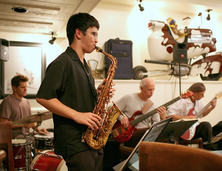 a man standing next to a musical instrument