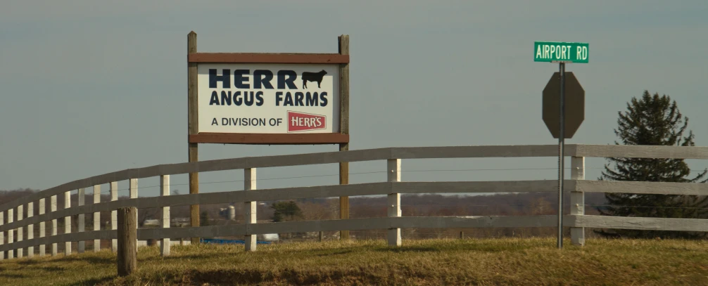 a sign and some signs are posted near a fence