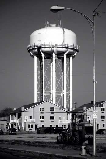 two big water towers on the side of a road