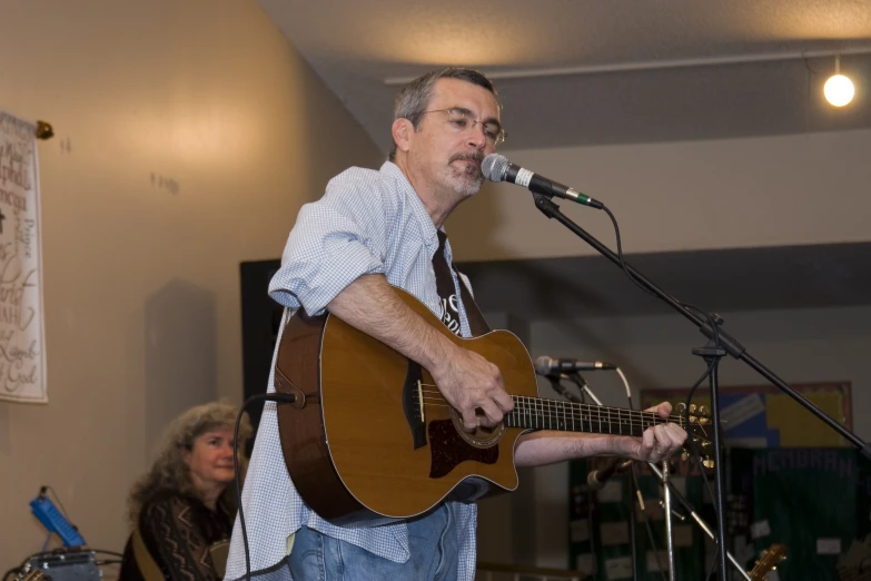 a man that is standing up playing guitar