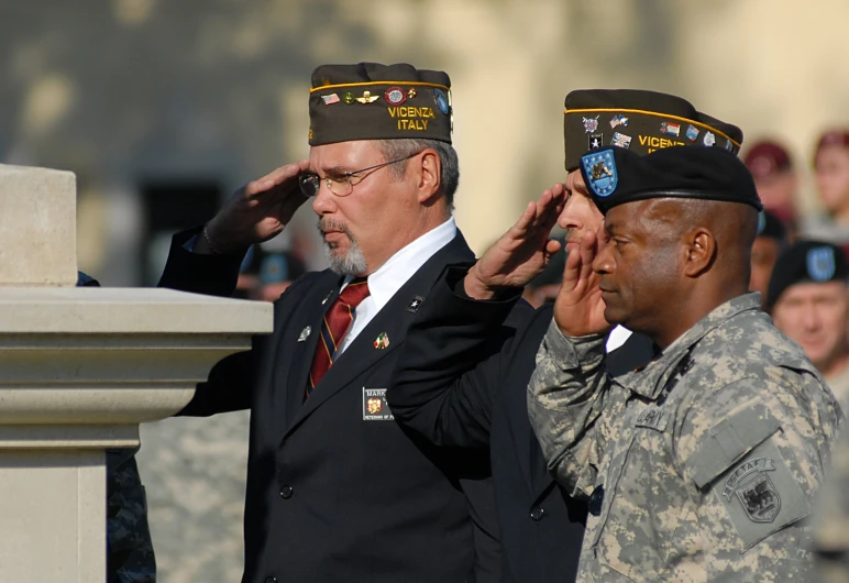 some men are getting dressed in military clothing