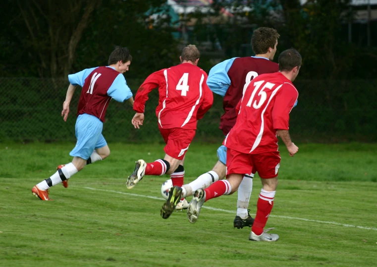 there is one goalie jumping after the ball during a game