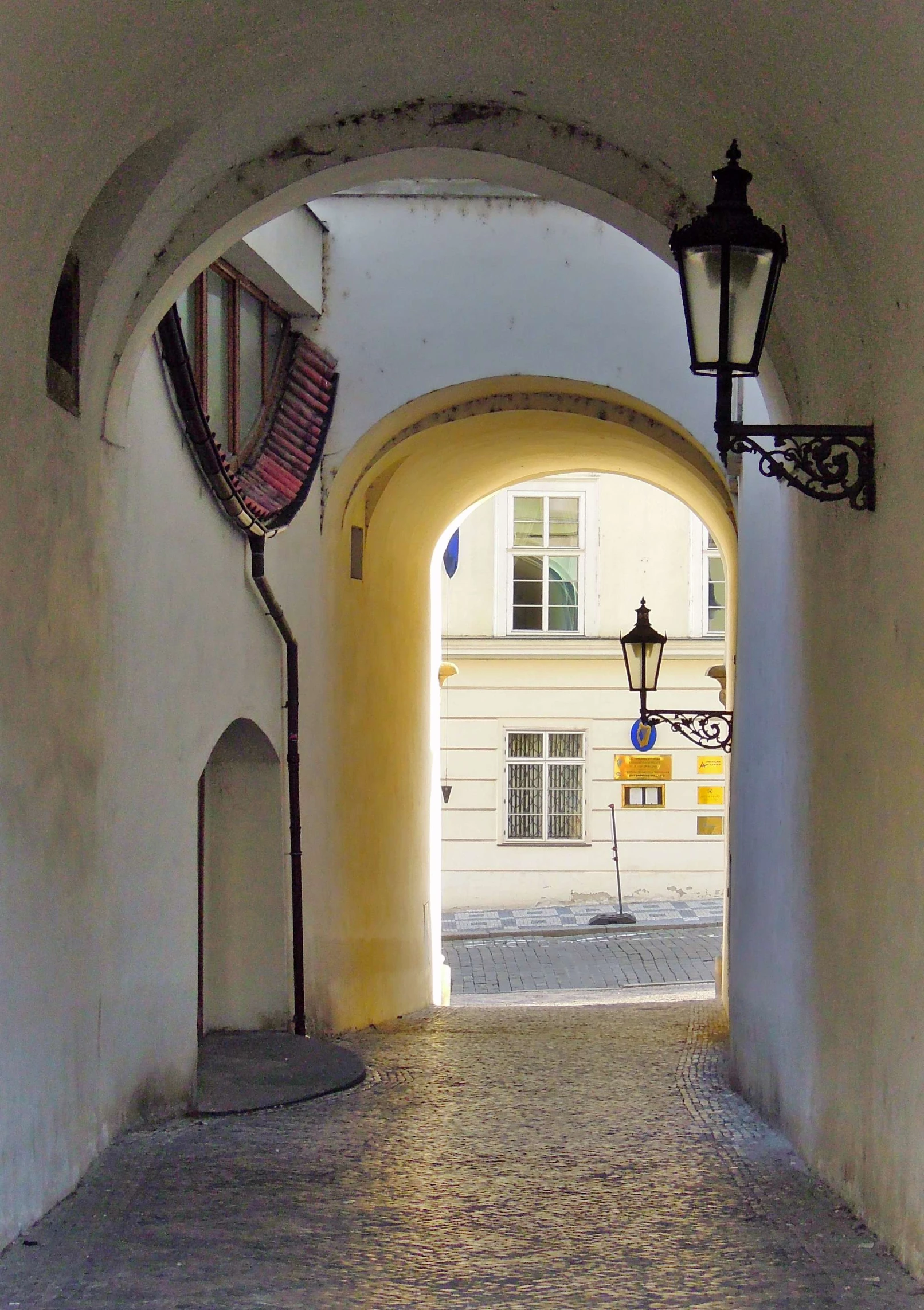 a white building with a light on a small hallway