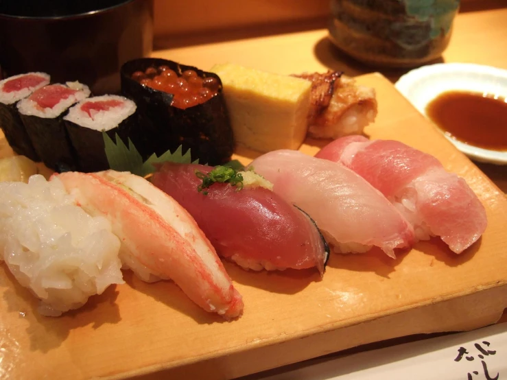 the sushi dish has different types of meats and vegetables