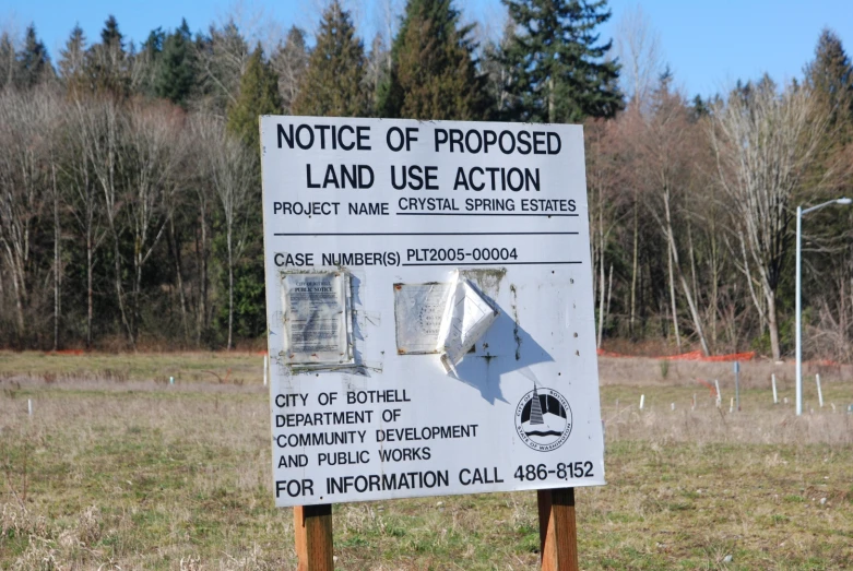 a notice sign on the side of a field