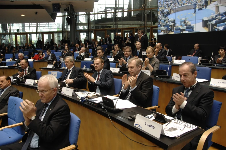 several business people sitting in a lecture hall