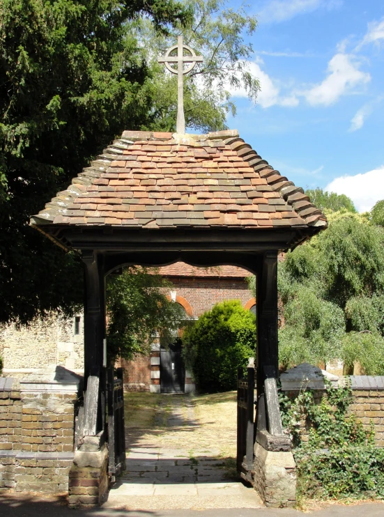 an old style gazebo with a cross on top