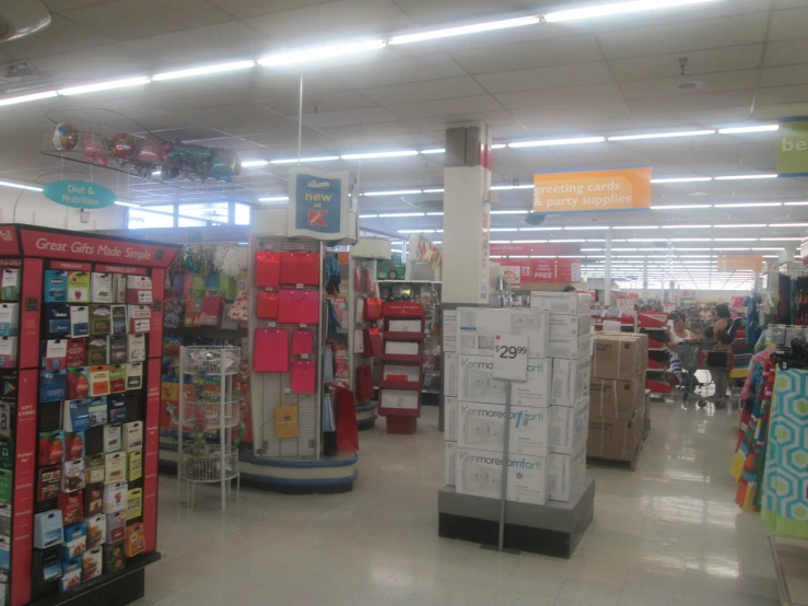 a large market with shelves and chairs with people walking by