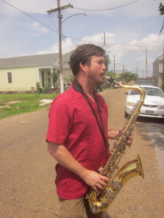 a man with a saxophone on a side walk