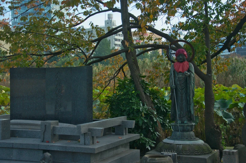 the tall statue stands next to the gravestones