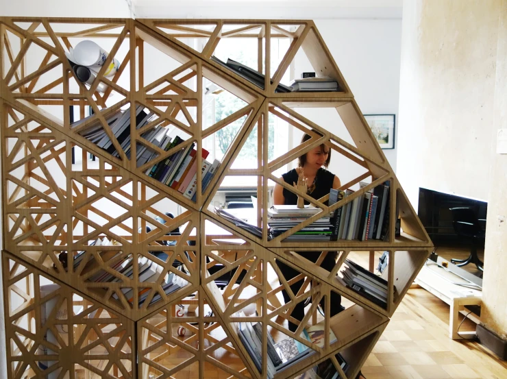 a person sitting down in a room with books