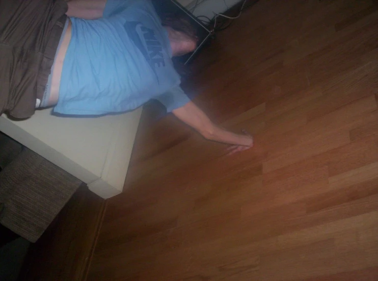 man laying on the floor in his pajamas