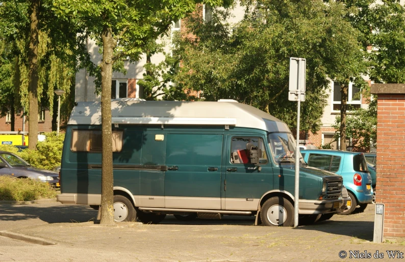 two vans parked along the side of a street