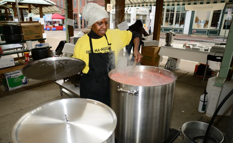 a person is pouring soing in a pot with a straw