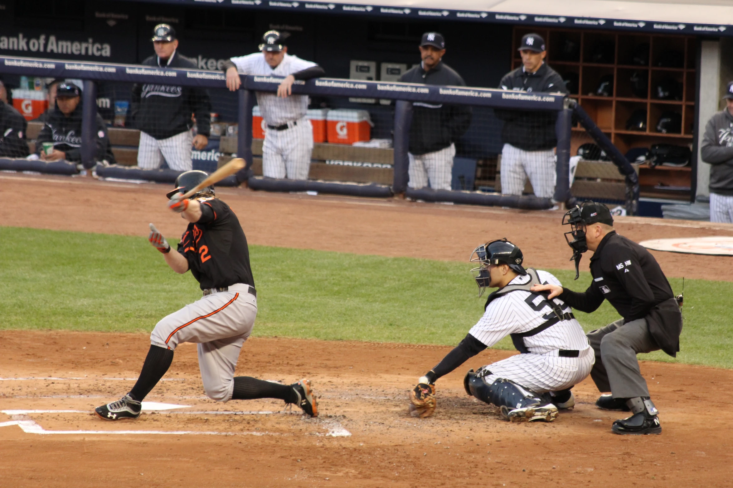 a baseball player taking a swing at a ball