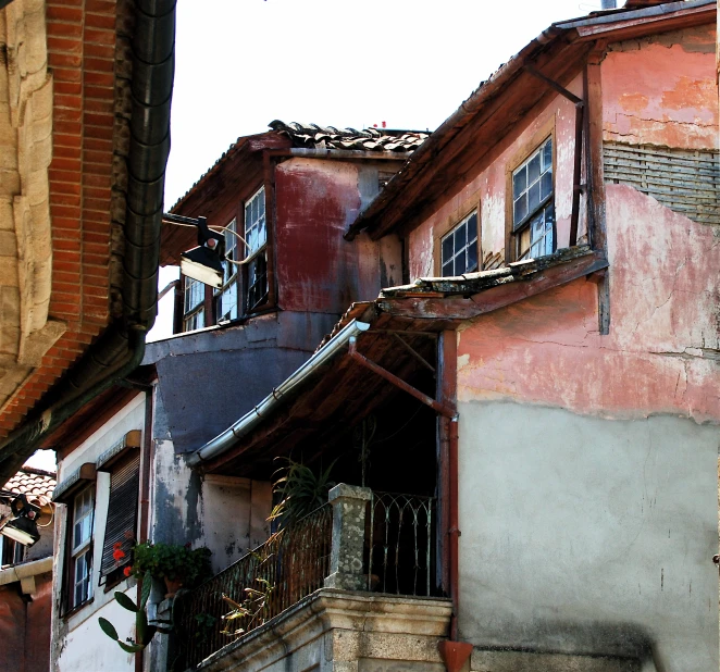 an outside view of old buildings, including a balcony