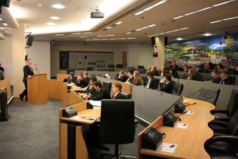 a room filled with people sitting at desks