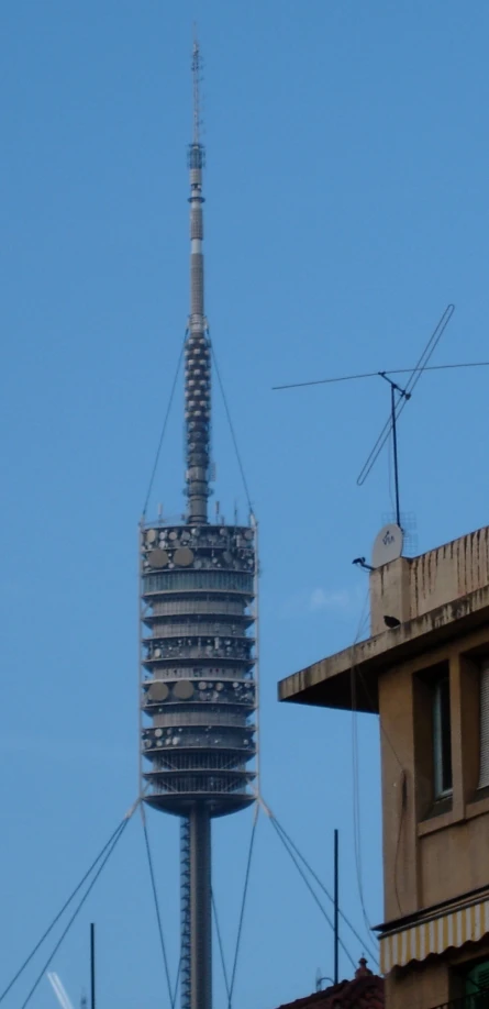a very tall antenna tower towering into the air