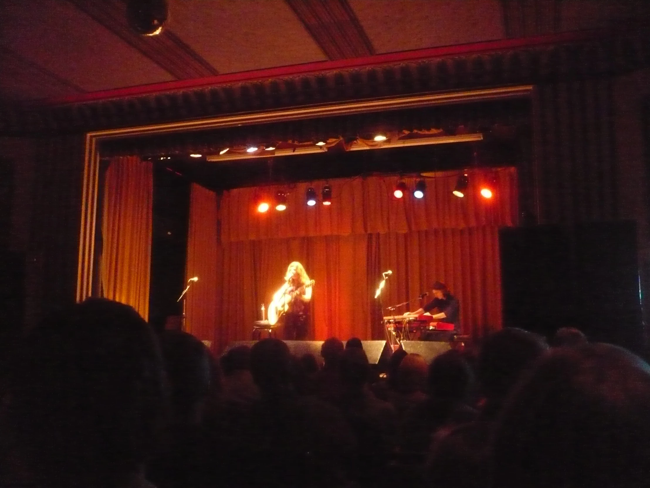 people are standing on stage with lighting and music equipment