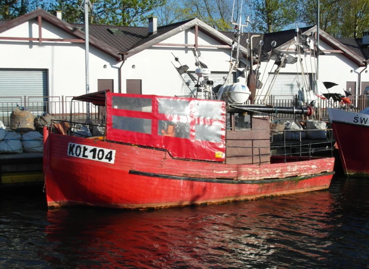 a boat that is red and is in the water