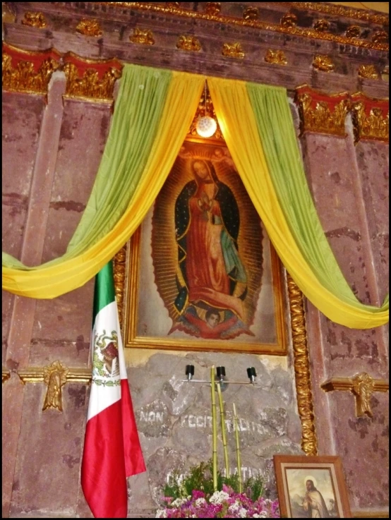 the altar with an image above has a cross