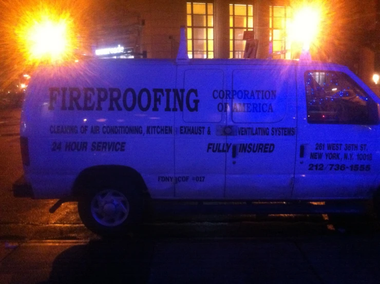 a white fireproofing van sitting in the street