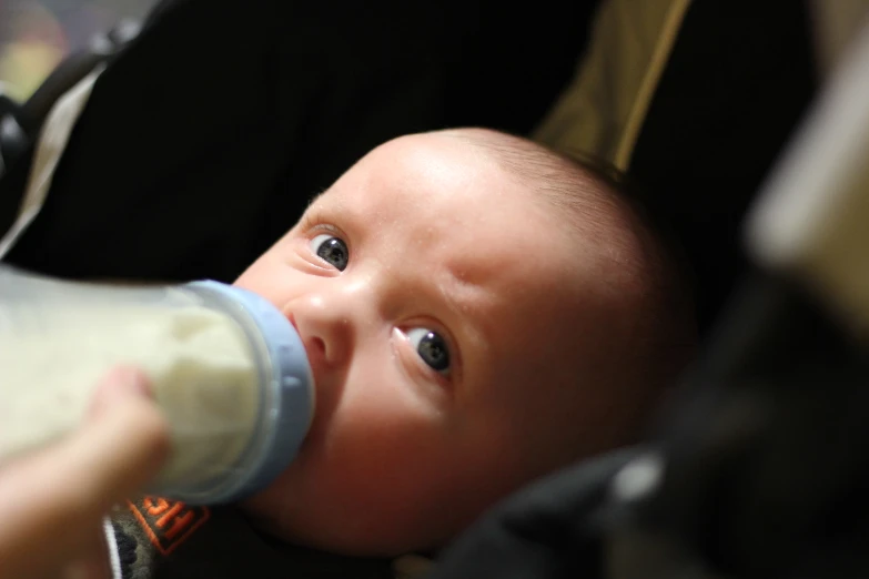 a close up of a baby's face with its mouth wide open