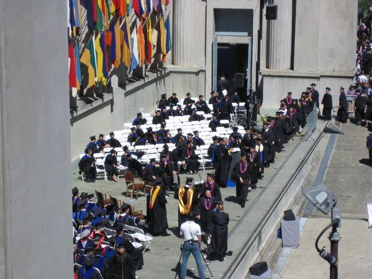 a graduation procession of students at the entrance of a building