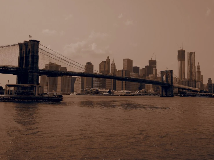 a large bridge in front of the city skyline