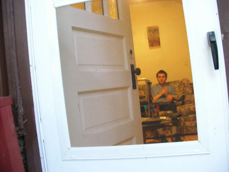 a man sitting in front of a closed door