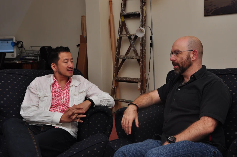 two men having conversation while seated in a room