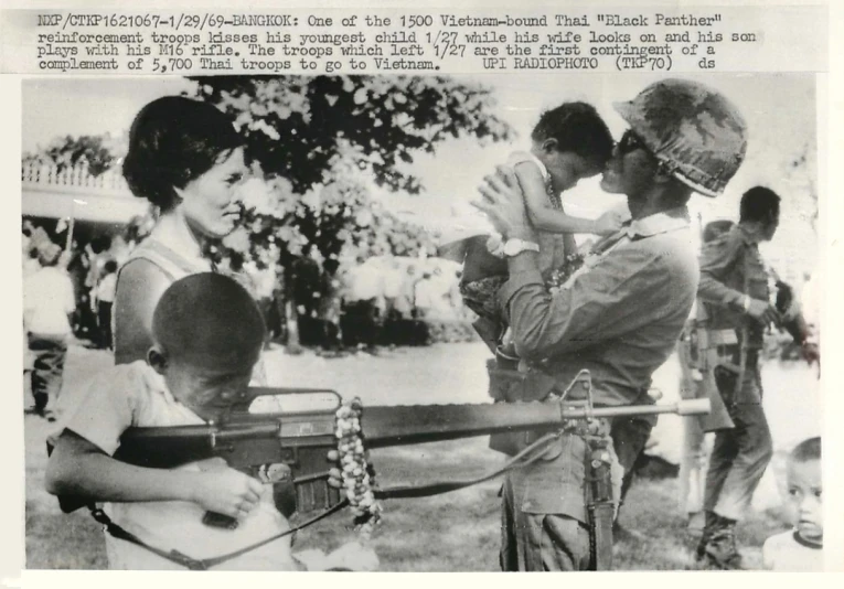 an old picture shows two boys playing with an infant