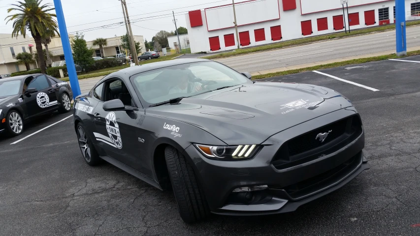 a mustang driving on the highway with other mustangs