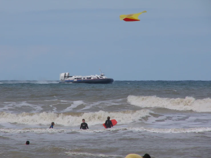 the small boat is in the ocean near the people