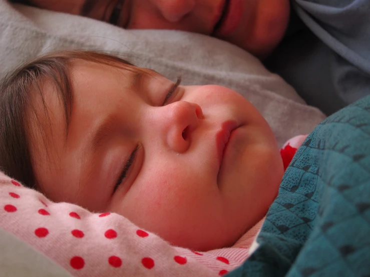 a baby is asleep on a pillow with his eyes closed