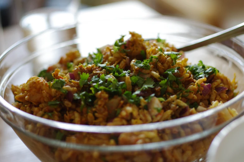 a dish with meat and onions in a glass bowl