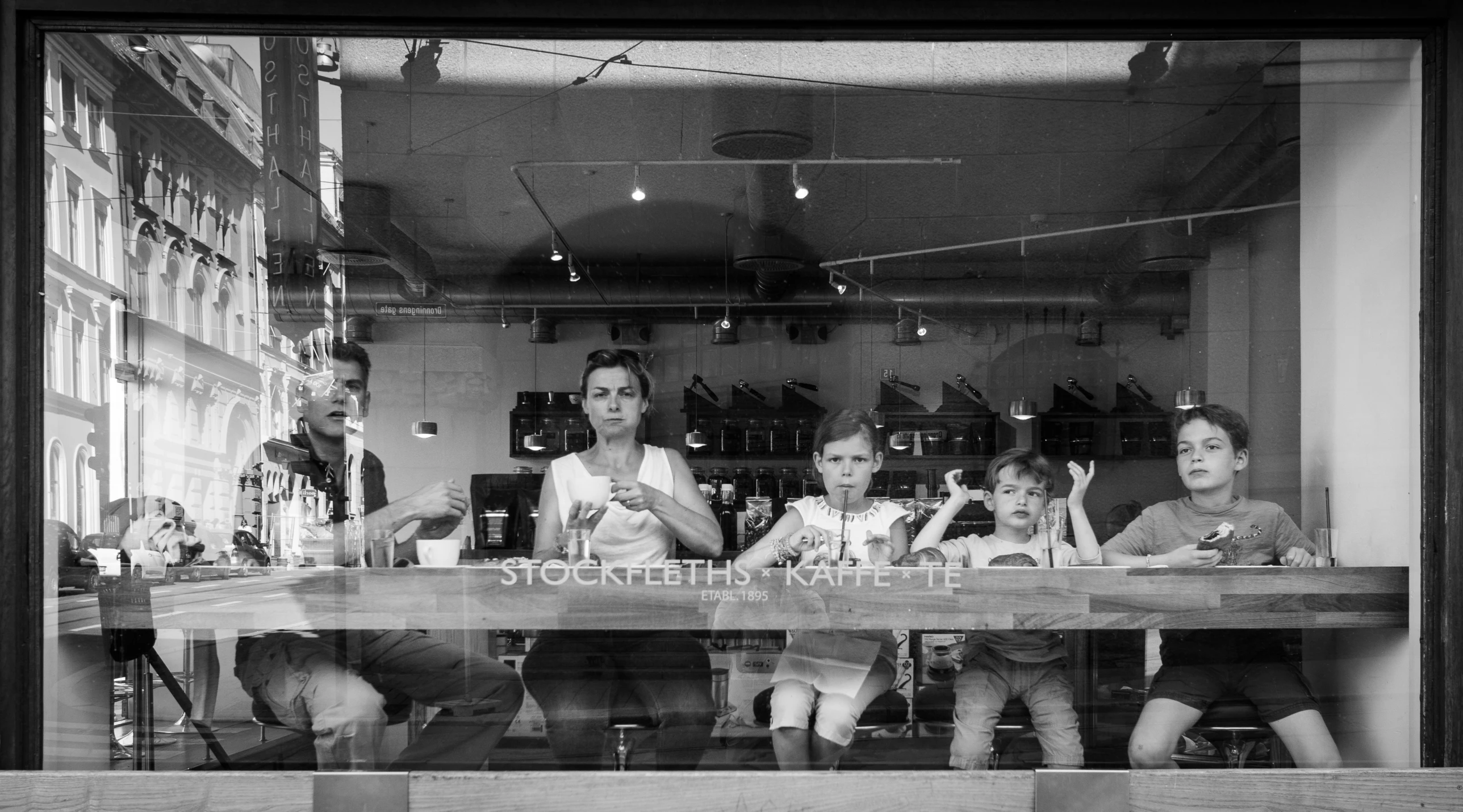 a black and white po of five people in the window