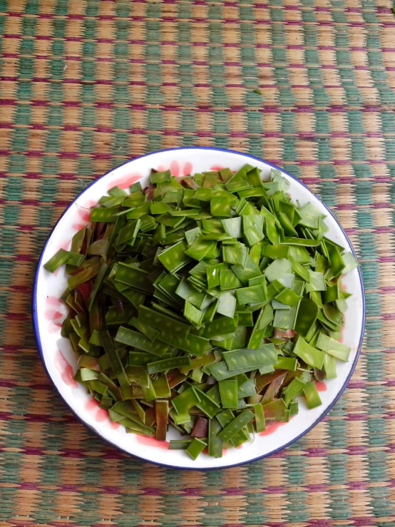 a close up of a bowl of cut grass