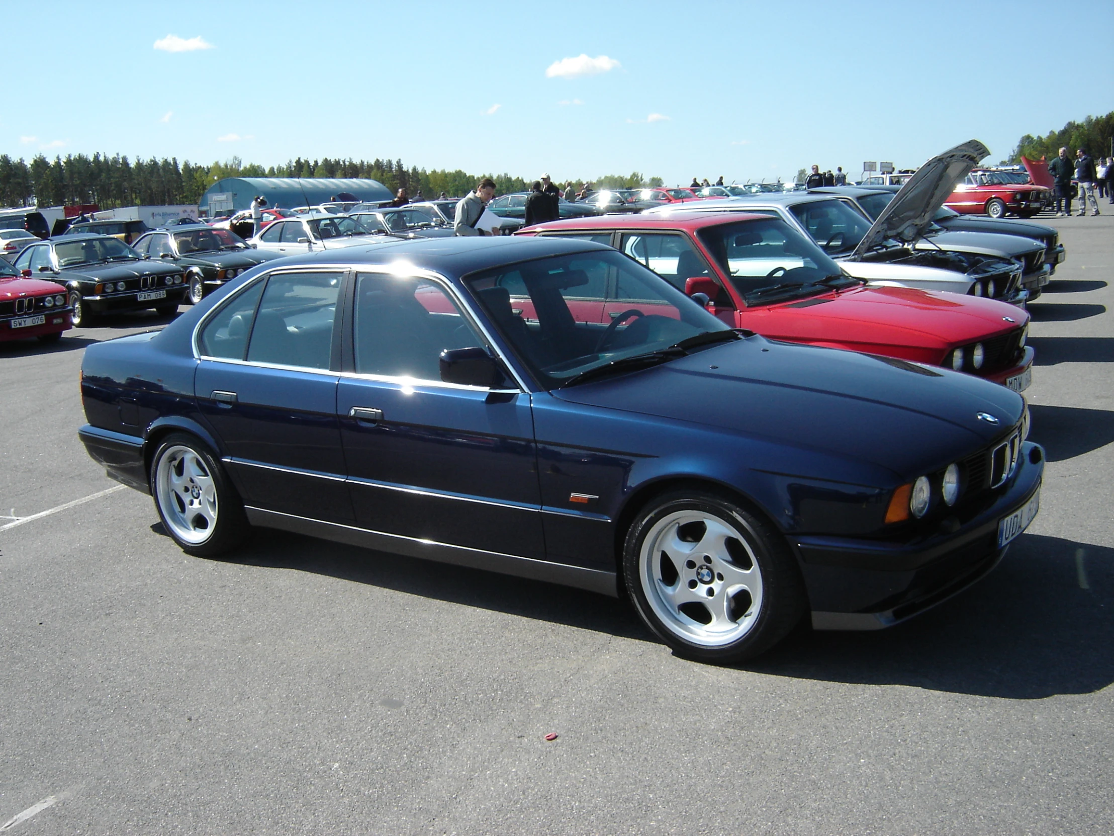 the black bmw is parked in the parking lot